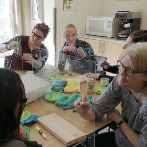 a classroom of 4 women creating art